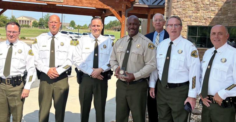 Lt. Travis Walker (fourth from left) was accompanied by Jones County Sheriff Butch Reece (back row), Capt. Kenny Gleaton, Capt. Shane Moody, Chief Deputy Earl Humphries and Capt. Ed Bailey at the July 1 ceremony. CONTRIBUTED