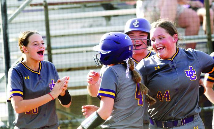 Raylee Harris (4) is mobbed by her teammates as she cross home plate after ripping a homer last week against Locust Grove. BRAD HARRISON/Staff