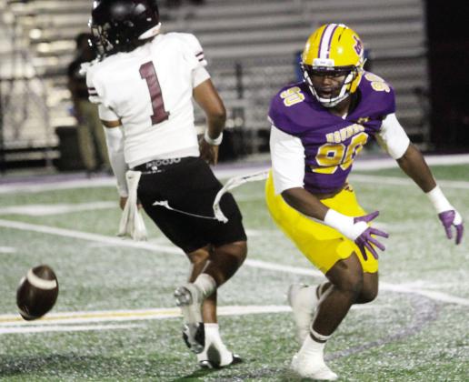 Defensive end Isaac Elliott careens in to disrupt a passing attempt by Union Grove quarterback Tristin Sharpe. BRAD HARRISON/Staff