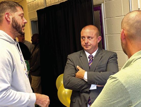 New Athletic Director Ross Couch, center, chats with JCHS head basketball coach Dylan Dupree, left, and head football coach Justin Montgomery, right, during Monday’s meet and greet event. BRAD HARRISON/Staff