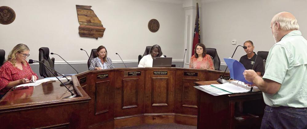 Melzar Nye, president of Technical Appraisal Services (far right), gives a summary report to the Board of Assessors June 4. DEBBIE LURIE-SMITH/Staff