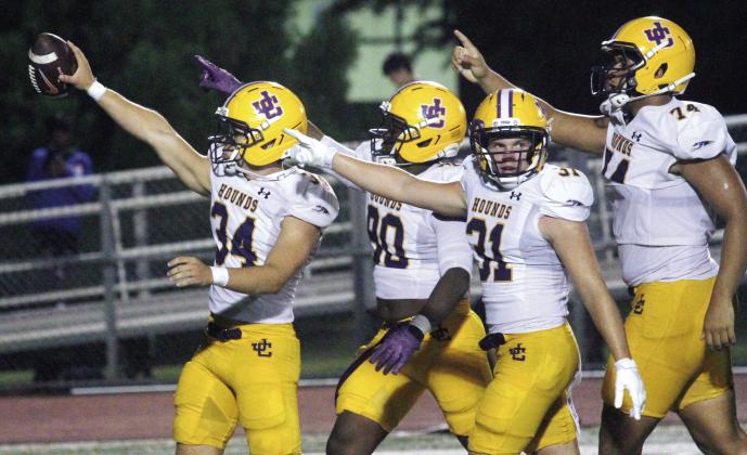 From right, Thad Smith, Isaac Elliott, Chase Hasty, and Thomas Gosier celebrate after the Greyhounds come up with a turnover on Friday against Locust Grove. BRAD HARRISON/Staff