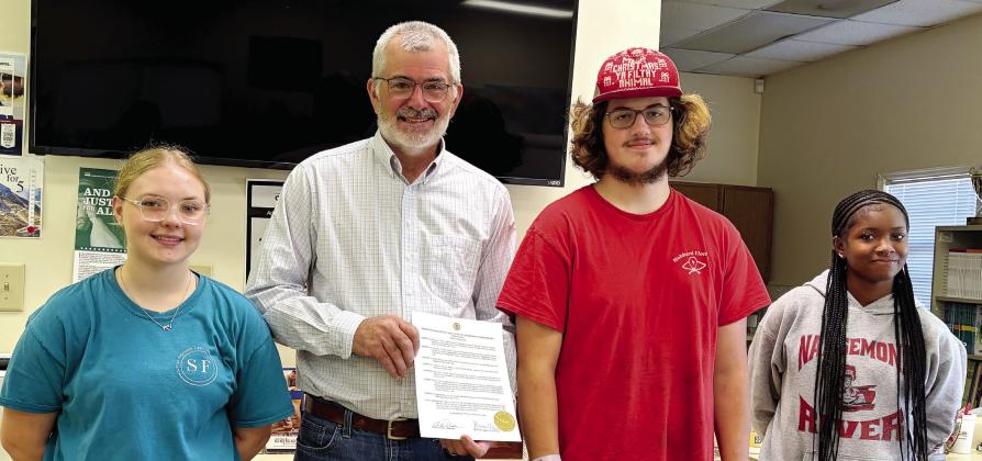 Jones County Board of Commissioners Chairman Chris Weidner (second left) presents Adult Education Students with a proclamation honoring Adult Literacy Day. DEBBIE LURIE-SMITH/Staff