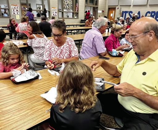 Grandparents eating breakfast with their granddaughters during Grandparent’s Day at Turner Woods Elementary School.