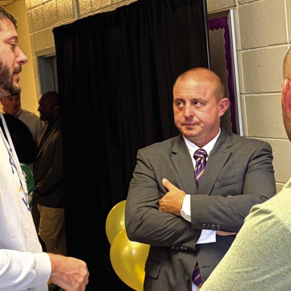 New Athletic Director Ross Couch, center, chats with JCHS head basketball coach Dylan Dupree, left, and head football coach Justin Montgomery, right, during Monday’s meet and greet event. BRAD HARRISON/Staff