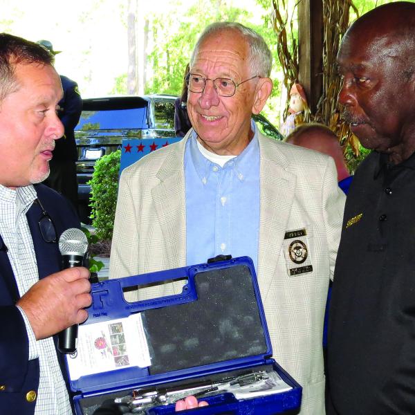 GSA president Sheriff Noel Brown (l-r) and Sheriff Butch Reece make a presentation to Sheriff Logan Marshall. CONTRIBUTED