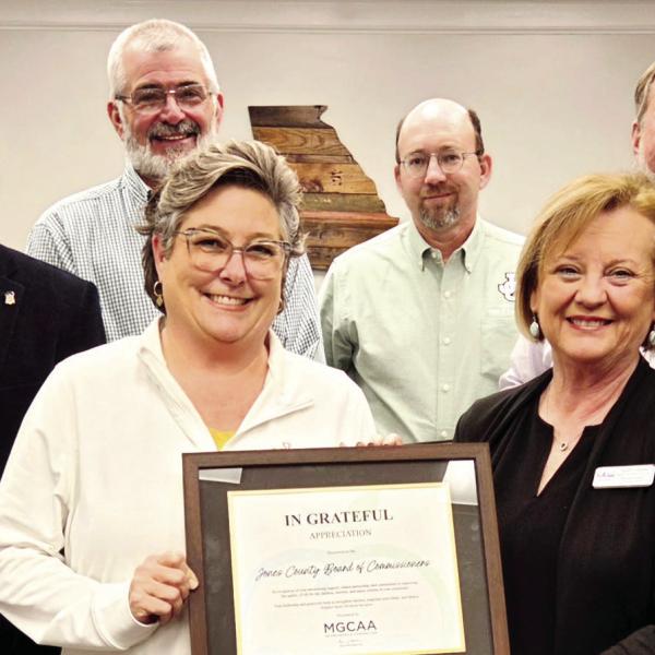 Tammy Sosebee (right front) with the Middle Georgia Community Action Agency and commissioners. Photo by James Collins