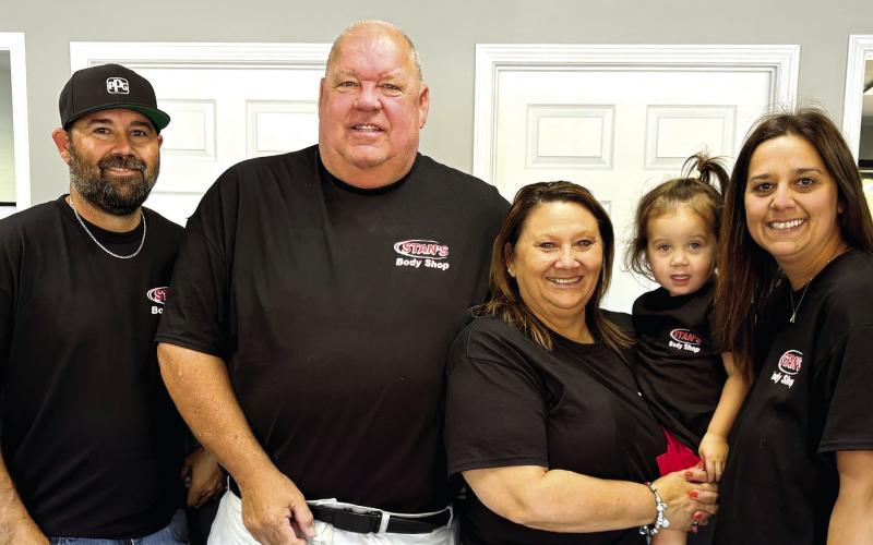 Members of the Stanford family — Marcus (l-r), Jeff, Kandy, Ansley and Amber — in the body shop office after the business reopened last week. DEBBIE LURIE-SMITH/Staff