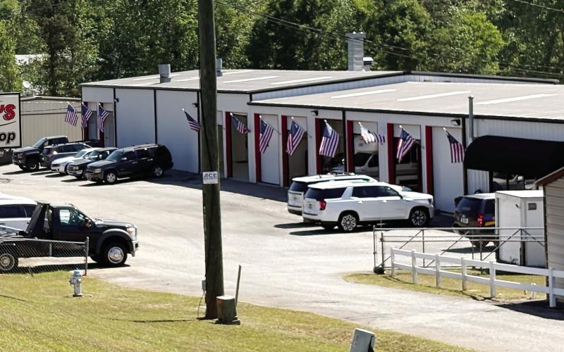 Stan’s Body shop is open for business as of April 20 with flags flying to celebrate. DEBBIE LURIE-SMITH/Staff