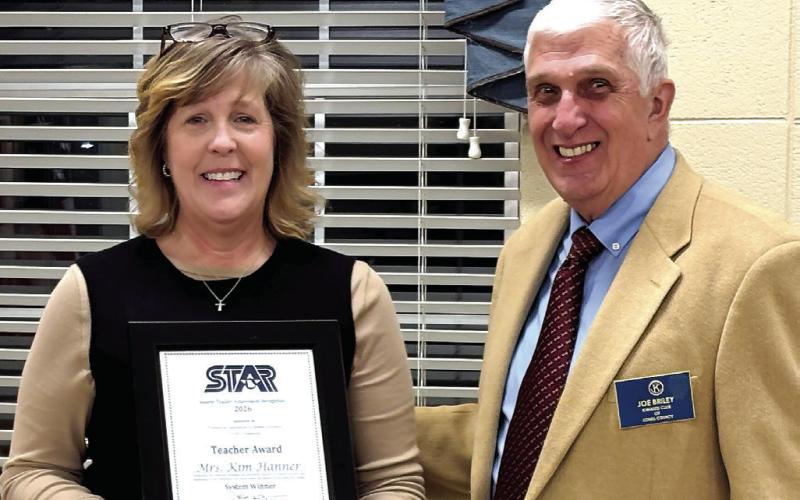 Star Teacher KIm Hanner receives her award from Briley. DEBBIE LURIE-SMITH/Staff