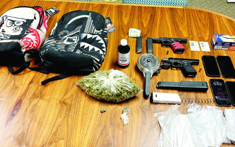 Evidence seized in the March 11 arrests include a large bag of suspected marijuana, firearms and ammo. CONTRIBUTED
