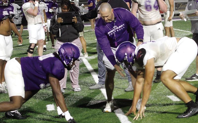 Greyhounds across multiple positions get ready to initiate contact during ‘board drills’ as part of spring practice. BRAD HARRISON/Staff