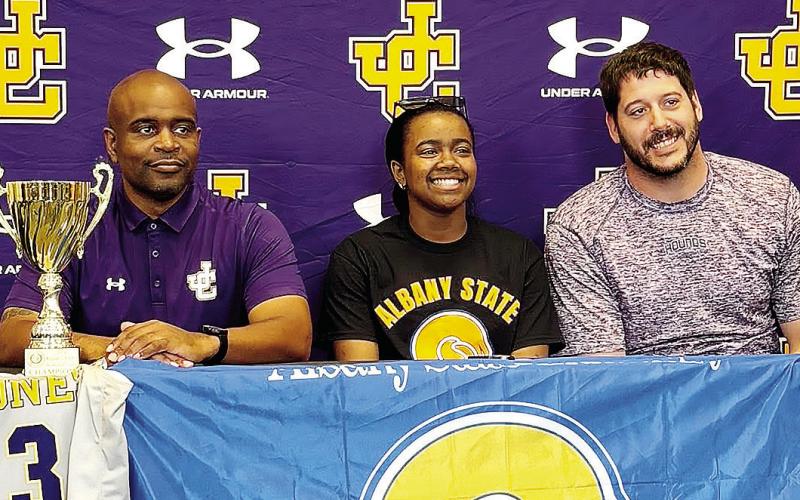 Autumn Coleman, center, smiles during last week’s ceremony in which she signed with Albany State. CONTRIBUTED