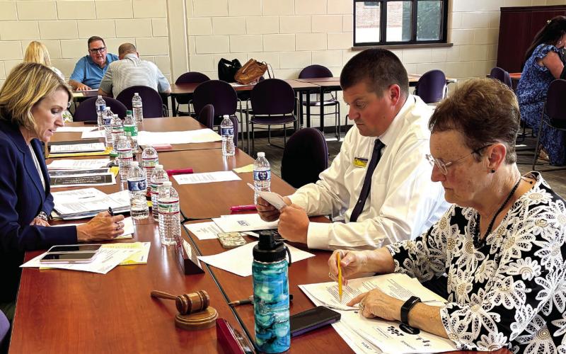 Jones County Superintendent Dr. Jessica Graves (l-r), JCHS Principal Chance Scott and Board Chairman Ginger Bailey work on norms and protocols. DEBBIE LURIE-SMITH/Staff