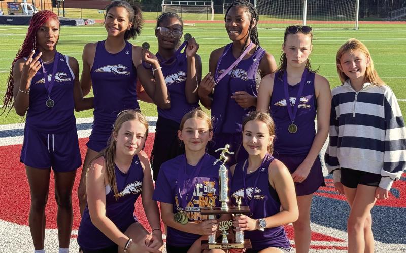 Jones County’s girls middle school track runners happily pose after last week’s second-place finish. CONTRIBUTED