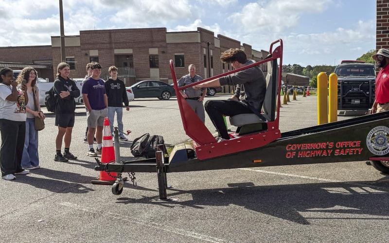 Jones County High School students take turns on the Seatbelt Convincer April 3, set up at the school by the Governor’s Office of Highway Safety in coordination of a grant received by the Gray Police Department. DEBBIE LURIE-SMITH/Staff