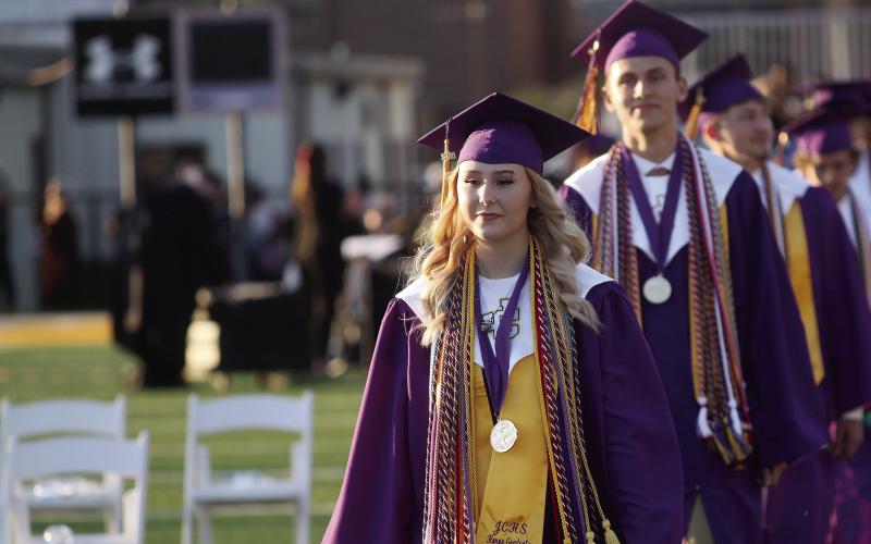 Valedictorian Ariana Epps and Salutatorian Aaron Varnadoe lead the processional at Jones County High School’s 2026 graduation ceremony that was held on the football field. The ceremony had been held in Milledgeville at Georgia College’s Centennial Center for the past several years. BRAD HARRISON/Staff