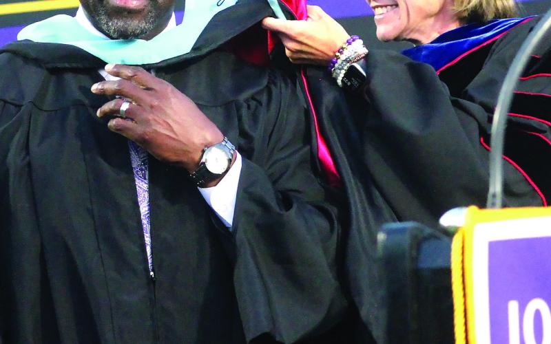 School Superintendent Dr. Jessica Graves (left) presents JCHS Principal Dennis Woolfolk with his hood for the achievement of Specialist in Instructional Technology at the May 15 event. Photos by BRAD HARRISON/Staff
