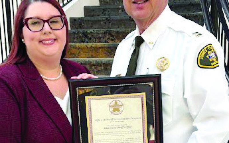 Administrative Coordinator Brittany Marks and Capt. Shane Moody with the certification plaque. CONTRIBUTED