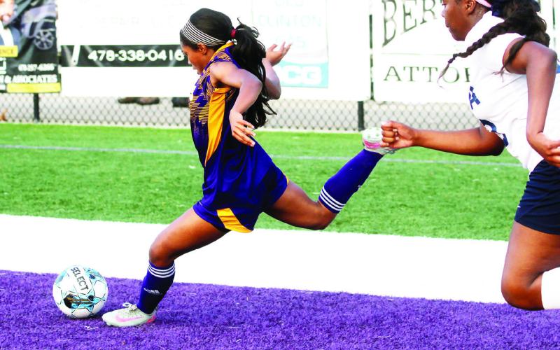 Elissa Taylor powers the ball toward the net against ELCA. BRAD HARRISON/Staff