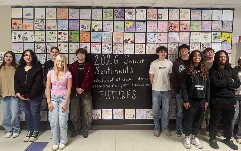 JCHS English teacher Crystal Burt (far right) and her senior student class in front of one of their final assignments. CONTRIBUTED