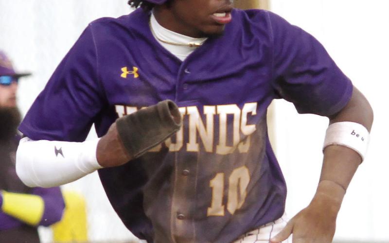 Amir Harris scores a run against Hampton after stretching a single into a double and stealing third. BRAD HARRISON/Staff