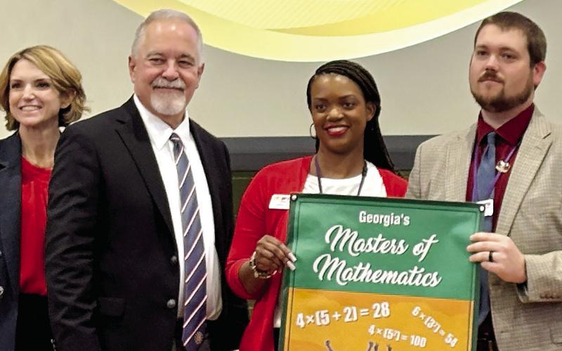 The math leaders award is accepted by GSMS Asst. Principal LaMisha Clark and Principal Zachary Griffin. DEBBIE LURIE-SMITH/Staff