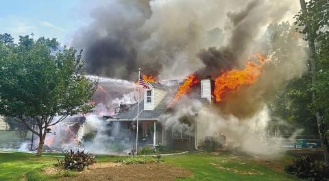 Smoke and flames appeared to come from every eve of the home during the blaze. CONTRIBUTED