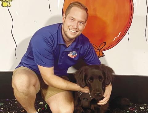 Joel Shiver, the owner of Gray-8-Skate Family Entertainment Center, with his new dog, Rink. ALAINA CLARKE/Staff