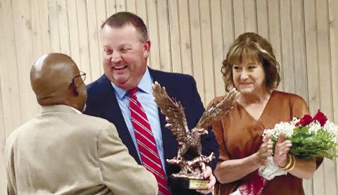 Gray Councilman David Tufts (l-r) presents Police Chief Adam Lowe with the BSA Golden Eagle Award at a Oct. 12 reception in his honor as his Chandra applauds. DEBBIE LURIE-SMITH/Staff