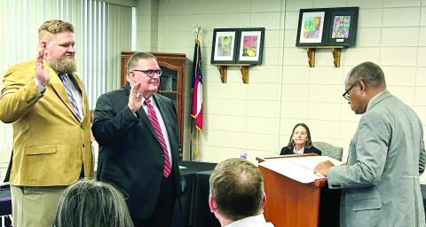 New Board of Education member Brady Skinner (l-r) and returning board member Kim Washburn are given their oaths of office from Probate Judge Lewis Patterson at the beginning of the Jan. 9 work session. DEBBIE LURIE-SMITH/Staff