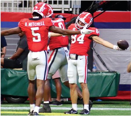 AD Mitchell (5) and Ladd McConkey (84) shrug one o_ after McConket nds the end zone for the second time of the day before halftime of the game against the Oregon Ducks last Saturday. BRENDAN KOERNER/Staff