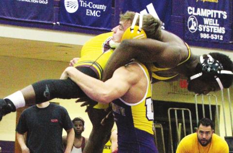 Bryce Boland upends his opponent in an early-season match for the Greyhounds. BRAD HARRISON/Staff