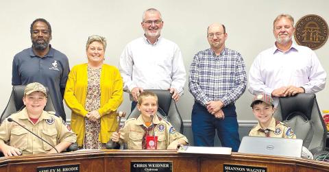 After their question and answer session with Jones County Commissioners, Cub Scout Troop 485 Webelos took the commissioners’ seats, including access to the chairman’s gavel. DEBBIE LURIE-SMITH/Staff
