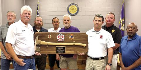 Karl Zimmer (left) is presented with a plaque from GFD Chief Keith Eisele at the June 16 meeting of city committees. DEBBIE LURIE-SMITH/Staff