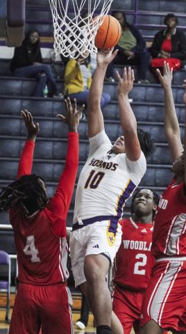 Tyler Wold, who led the Greyhounds on Saturday with 12 points, fights for an offensive putback. BRAD HARRISON/Staff