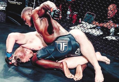 Torrez Finney takes his opponent down to the ground during Saturday’s MMA bout. CONTRIBUTED