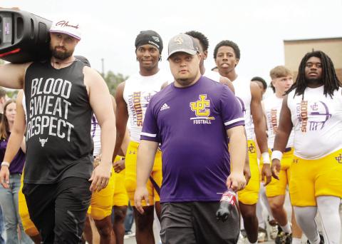 Greyhounds players and coaches make their way through the Hound Walk earlier this season against Stockbridge. BRAD HARRISON/File photo