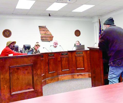 Ty Clements (at podium) was one of the citizens with questions for the commissioners at the Jan. 28 hearing about HB 581. DEBBIE LURIE-SMITH/Staff
