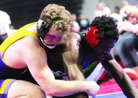 Jacob Skinner holds his opponent down, going on to win his _fth-place match. BRAD HARRISON/Staff