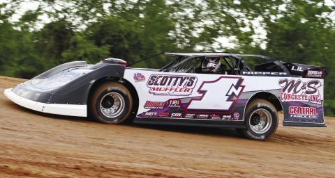 Jordy Nipper whips his car ariund the track during a recent race at Cochran Motor Speedway. BRAD HARRISON/Staff