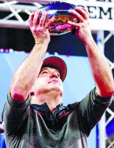 Georgia head football coach Kirby Smart displays the Peach Bowl trophy after the Bulldogs secured their trip to Los Angeles to face TCU. TONY WALSH/UGA Athletics