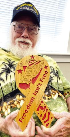 Jones County veteran and committee member Roger Hawke displays a sample of the plaques he made to be distributed at this year’s event. DEBBIE LURIE-SMITH/Staff