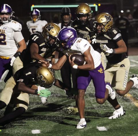 Travis Miller (11) bulls his way toward the end zone during overtime on Friday against McDonough. The Greyhounds scored one play later to win 27-24. >> SEE FULL COVERAGE IN SPORTS >> PAGE C1 BRAD HARRISON/Staff