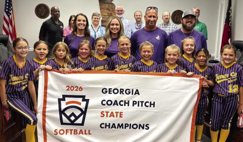 Members of the Jones County 8U Coach Pitch State Champion softball team and their coaches are celebrated by the Jones County Board of Commissioners at their July 6 meeting. DEBBIE LURIE-SMITH/Staff