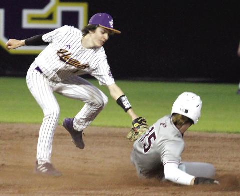 Colin Evans reaches down to tag out a Perry stolen-base attempt last Thursday. BRAD HARRISON/Staff
