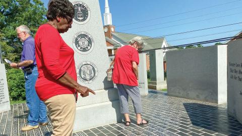 Family members and veterans view the newly engraved pavers at the Jones County Veterans Memorial. DEBBIE LURIE-SMITH/Staff Memorial.