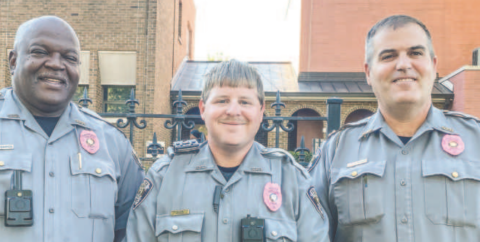 Lt. Thaxton Pennamon, Officer Josh Josey and Capt. Eric Maynard of the Gray Police Department display their pink badges they will wear through October. DEBBIE LURIE-SMITH/ Staff