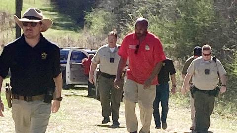 Jones and Putnam authorities walk back to their vehicles after recovering a body on Cedar Creek Sunday afternoon. LYNN HOBBS/Staff