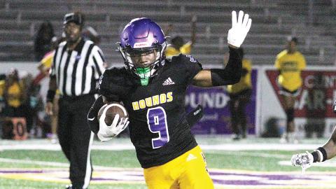 Greyhounds defensive back Andre Hall runs back an interception during the second half of Friday’s win. BRAD HARRISON/Staff